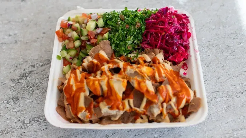 Kebab plate with salads, pickled cabbage and chilli sauce