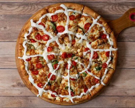 Pizza topped with garlic sauce on a wooden board